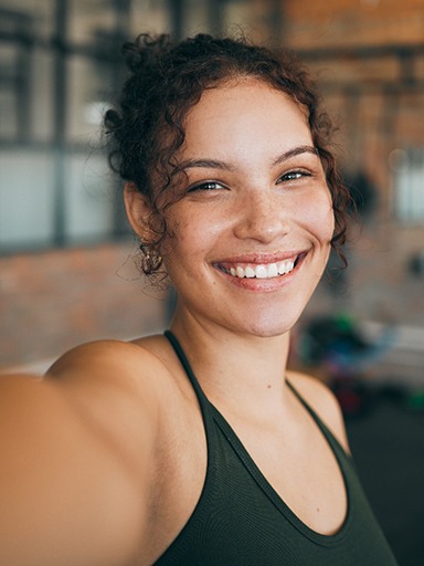Teenage girl smiling in a workout studio