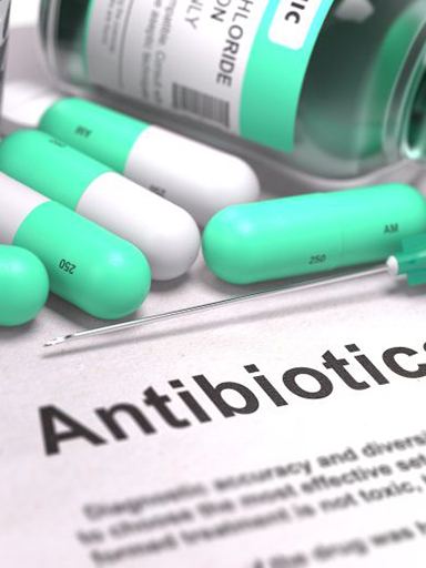 Variety of antibiotic medications on top of document