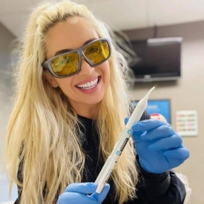 Dentist holding an instrument for treating lip-tie and tongue-tie