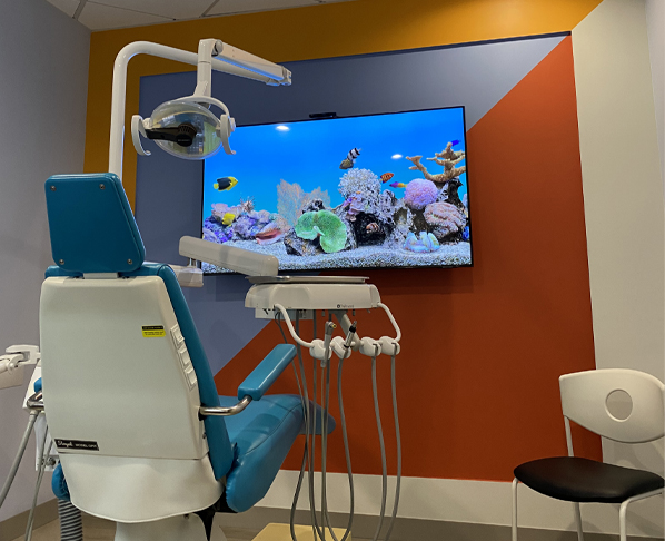 Dental chair and television monitor showing fish