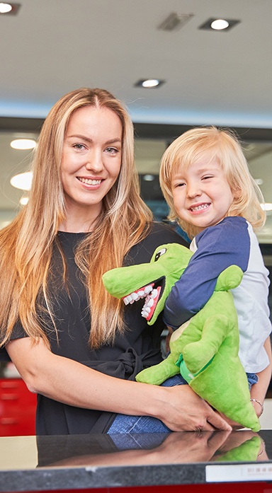 Parent and child paying for treatment at dental office