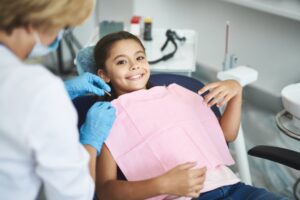 Child smiling before tooth extraction