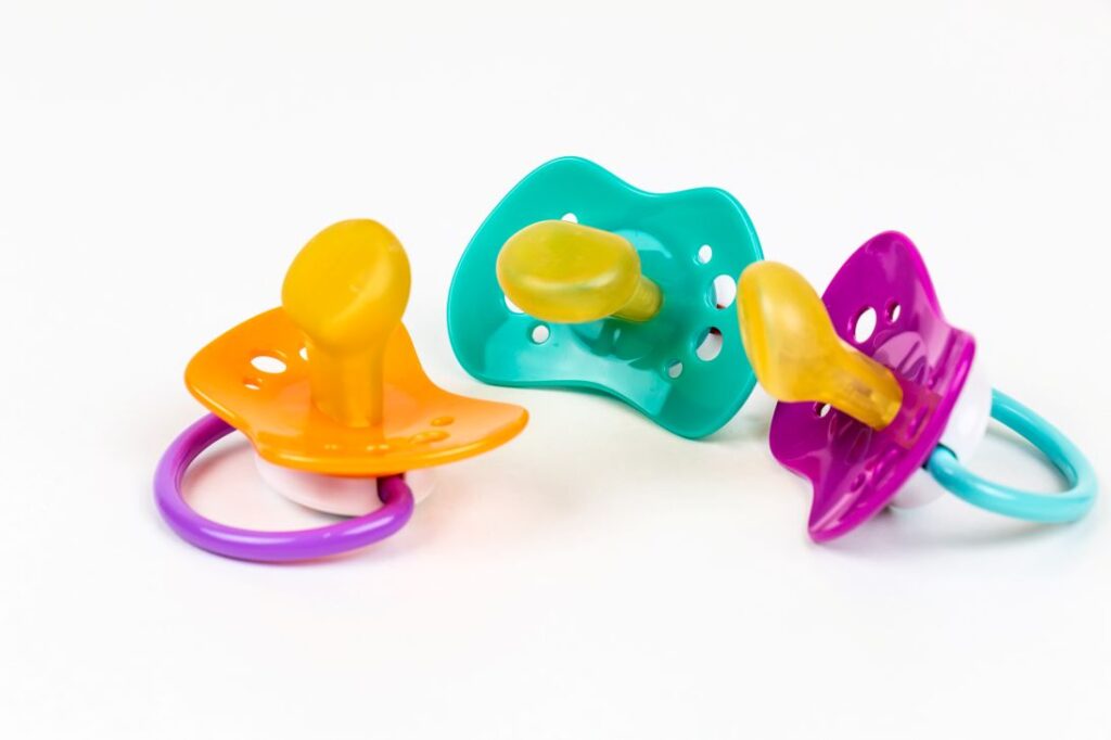 Colorful pacifiers on a white background